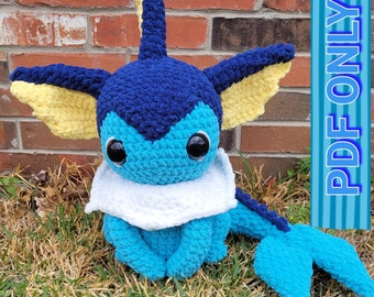 May include: A crocheted blue and yellow Pokemon plush toy. The toy is sitting on a bed of green grass.