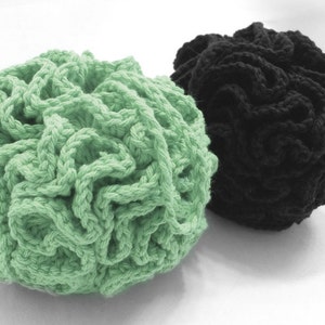 May include: Two crocheted balls, one green and one black. The balls are made of thick yarn and have a textured, bumpy surface.