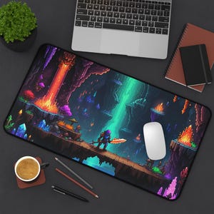 May include: A pixelated gaming mouse pad featuring a fantasy landscape with a waterfall, glowing crystals, and a character holding a sword. The background is a dark cave with lava flowing down the side.
