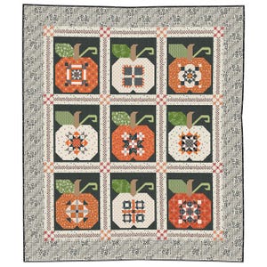 May include: A patchwork quilt featuring nine stylized pumpkin blocks in shades of orange, white, and green against a dark background. The pumpkins have intricate geometric designs. The quilt has a patterned border with a floral design.