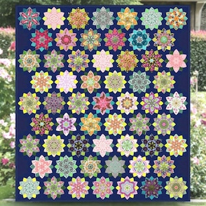 May include: A quilt with a navy blue background and a repeating pattern of colorful, star-shaped flowers with intricate designs. The flowers are outlined in yellow.