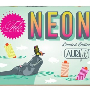 May include: A box of Aurifil thread in a limited edition "Neon" collection by Tula Pink. The box features a colourful illustration of a hippopotamus with a butterfly on its head, surrounded by spools of thread and fish.