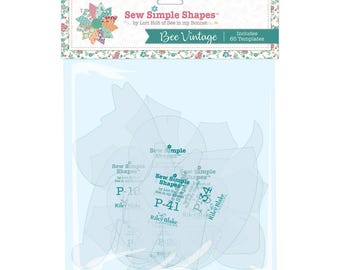 May include: A packet of sewing templates, labelled "Sew Simple Shapes" by Lori Holt of Bee in my Bonnet. The packet includes 65 templates and is titled "Bee Vintage." The templates are transparent with various shapes and the Riley Blake Designs logo.