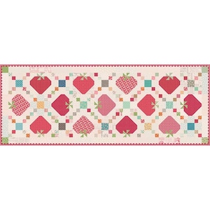 May include: A rectangular quilt with a repeating pattern of red and pink strawberries with green stems on a cream background. The quilt has a scalloped pink border. Small, colourful square accents are interspersed throughout the design.