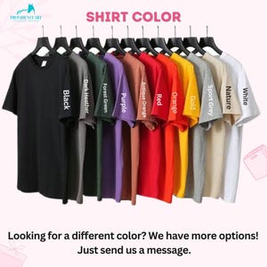 May include: A row of t-shirts hanging on hangers, showing a variety of colors, including black, dark heather, forest green, purple, antique orange, red, orange, gold, sport grey, nature, and white. The text "SHIRT COLOR" is at the top of the image.