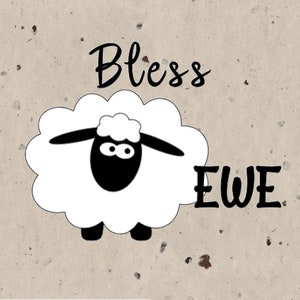 May include: A white sheep with a black face and a black nose. The sheep is standing on a beige background with the text "Bless Ewe" written in black.