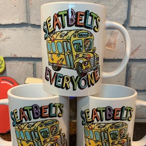 Magic School Bus 15oz mug, Take Chances Make Mistakes Get Messy, Seatbelts Everyone, Ms Frizzle