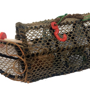May include: A brown and tan woven lobster pot with a red buoy and a red hook. The pot is made of a mesh material and has a rectangular shape.