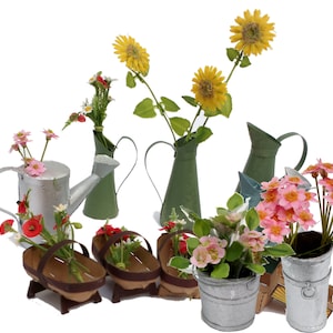 May include: A collection of miniature metal watering cans and flower pots, each filled with artificial flowers. The flowers include pink, red, and yellow blooms. The watering cans are painted in shades of green and silver.