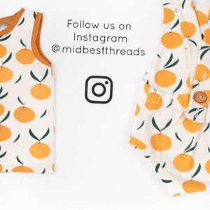 May include: Two baby outfits with a white background and orange fruit print. The text "Follow us on Instagram @midbestthreads" is at the top of the image. An Instagram logo is in the centre of the image.