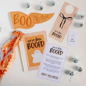 May include: A set of printable Halloween "Booed" cards with orange and white stripes. The cards feature a ghost illustration and the text "You've Been Booed!"  Enjoy your treats and keep the fun going!  Attach the "We've Been Booed" sign to your front door so neighbors know you've been booed!  Spread some Halloween cheer by packing up special treats and booing your neighbors.  Make sure to include this note and a "We've Been Booed" sign for them to use.  Happy Halloween!