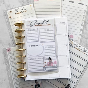 May include: A set of printable planner pages with a feminine design. The pages include a to-do list, a snapshot page, a bills due page, a notes page, and a weekly calendar page. The pages are decorated with floral illustrations and a woman in a stylish outfit.