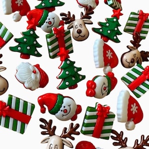 May include: A collection of assorted Christmas-themed buttons featuring various designs including reindeer faces, Santa Claus heads, green and white striped gift boxes with red bows, red Santa hats, and green Christmas trees with red star toppers.