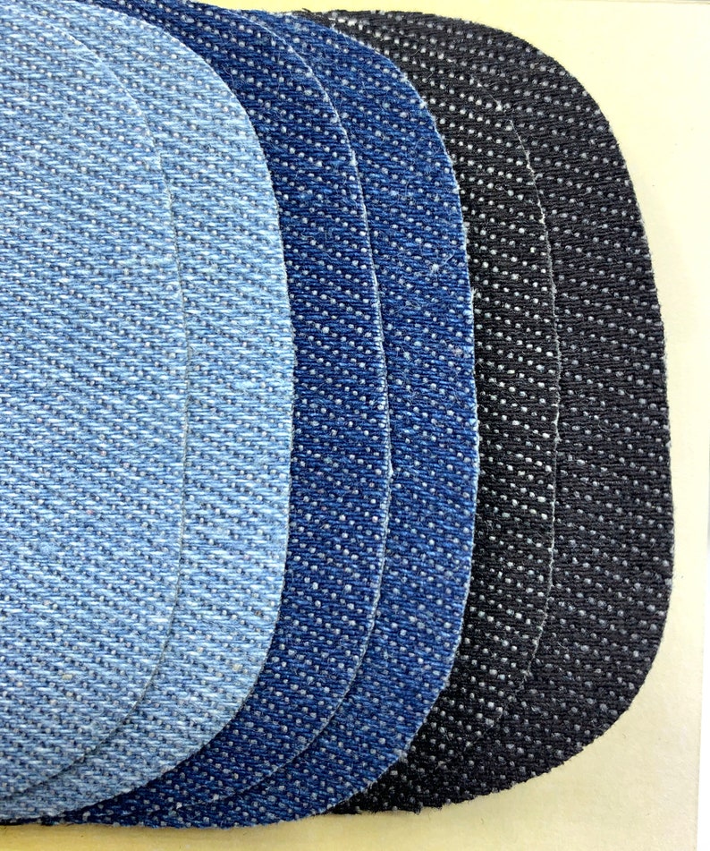 May include: Five denim fabric swatches in different shades of blue and black. The swatches are arranged in a semi-circle, with the lightest blue swatch at the top and the darkest black swatch at the bottom.