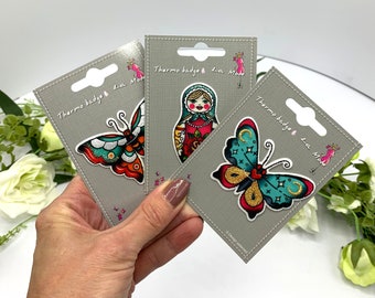 Tattoo motifs, iron on embroidered patches, butterfly and Russian Babushka doll designs