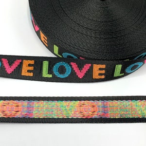 May include: Black webbing with the word "LOVE" repeated in rainbow colors.