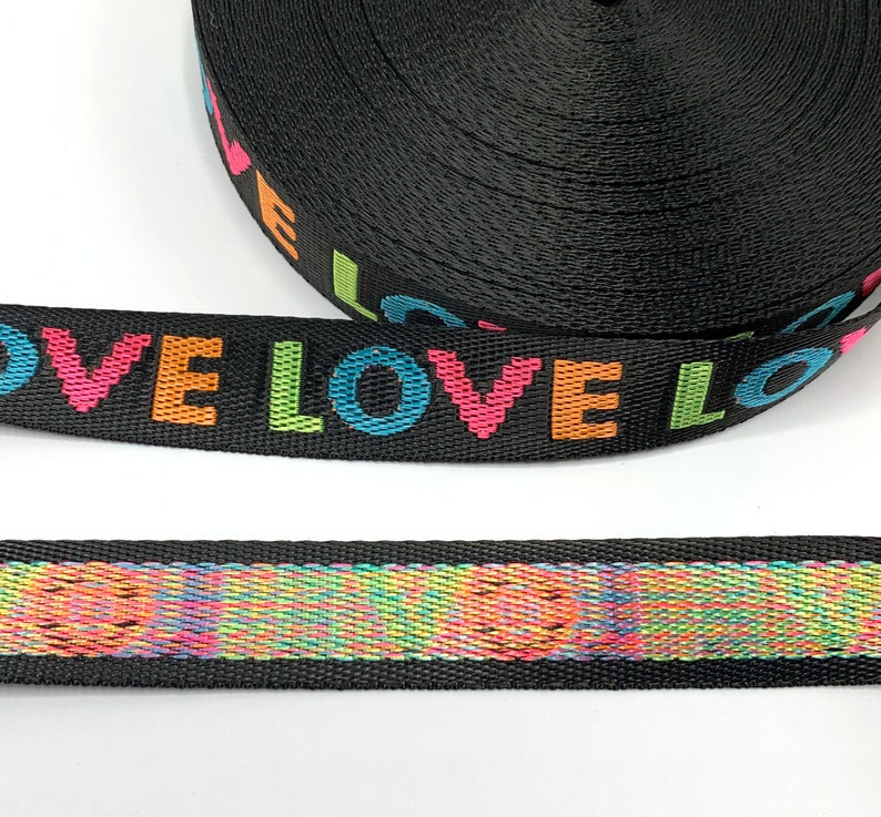 May include: Black webbing with the word "LOVE" repeated in rainbow colors.