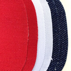 May include: Three fabric swatches in red, white, and blue. The swatches are oval shaped and have a textured surface.