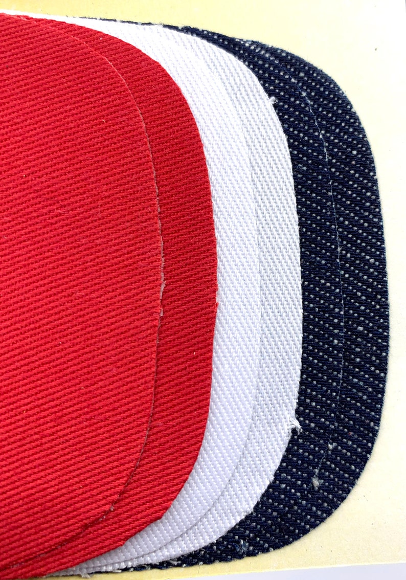 May include: Three fabric swatches in red, white, and blue. The swatches are oval shaped and have a textured surface.