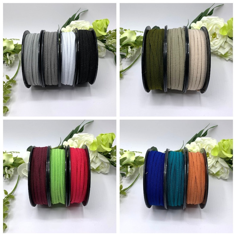 May include: A set of ten spools of elastic cord in various colors, including black, white, gray, green, red, blue, teal, and orange. The spools are arranged in pairs on a white surface.