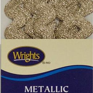 May include: Metallic medium rick rack trim in a shimmering gold color. The packaging includes the Wrights logo and text that reads "METALLIC MEDIUM RICK RACK". The trim is 0.5 inches wide.