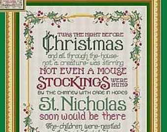 May include: A framed cross-stitch sampler with the text "Twas the Night Before Christmas." The text is in a decorative font, with a border of holly and berries. The frame is green and gold.
