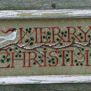 May include: A framed cross-stitch design with the words "Merry Christmas" in red lettering. Two white birds with red hats are perched on a branch with green foliage.