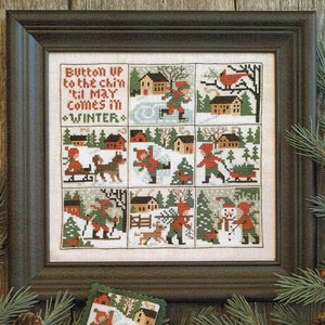 May include: A framed cross-stitch sampler with a winter theme. The sampler features a variety of scenes, including children playing in the snow, a cardinal on a branch, and a snowman. The text on the sampler reads "Button up to the chin 'til May comes in *WINTER*"