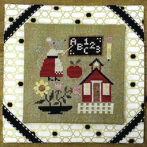 May include: Cross-stitch pattern featuring a mouse teacher standing in front of a red schoolhouse with a chalkboard that says "A B C 1 2 3".