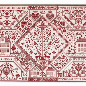 May include: A red and white cross-stitch sampler with a central diamond design featuring a tree, deer, and birds. The sampler includes houses, floral patterns, and text, including the name "JACOB DE GRAAF" and the year "2020".
