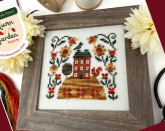 May include: Cross stitch pattern featuring a red house with a brown roof, surrounded by yellow sunflowers, orange tulips, and a beehive. The house is on a hill with a squirrel and a bird. The pattern is titled "Autumn Garden Palette 2023".