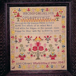 May include: A framed antique cross-stitch sampler in a dark wood frame. The sampler displays an alphabet, floral patterns, and a poem. The text reads "Jesus permit thy gracious Name to stand...Ann Olivers Work in the 11 year. 1849."