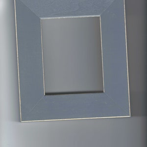 May include: A simple, gray picture frame with a slightly raised edge around the opening. The frame is made of wood and has a distressed finish.