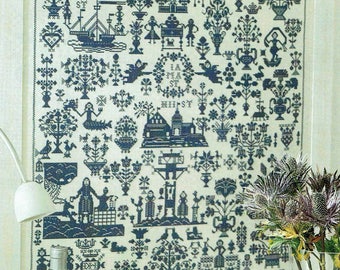 May include: A black and white cross-stitch sampler with a variety of designs, including flowers, trees, animals, and people. The sampler is framed and hanging on a wall. The text on the sampler reads "ABCDEFGHIKLMNOPQRSTUVWXYZIAMS×夏夏01830× MIIST HGSTIGST ST www. MINERALE NATURELLA w A MA ST MIST E".