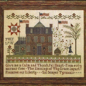 May include: A cross-stitch pattern featuring a brick house with a red roof, a star quilt, and a tree with red birds. The text "July 1776" is stitched above the house. The text "Give me a Calm and Thankful Heart From every murmur free. The blessings of Thy Grace impart. Preserve our Liberty. Sic Semper Tyrannis..." is stitched below the house.