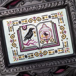 May include: A cross-stitch embroidery framed in black wood, depicting an open book with a black raven on one page and a bird in a cage on the other. The book is decorated with gold and purple details.