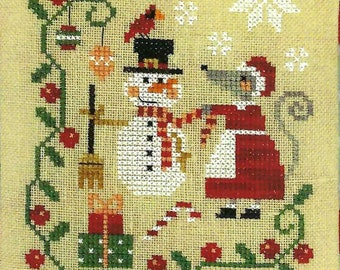 May include: Cross-stitch design featuring a snowman and a mouse in a Santa outfit. The snowman wears a black top hat and a red and white scarf. The mouse is in a red dress with a white apron. The background is a light tan color with red flowers and green vines.