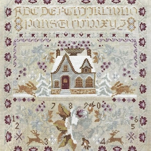 May include: A cross-stitch sampler featuring a winter scene with a snow-covered house, trees, and rabbits. The design includes text at the top and numbers and floral elements at the bottom. The color palette is soft, with shades of beige, gray, brown, and purple.