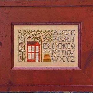 May include: A framed cross-stitch sampler with a red house, tree, and beehive design. The sampler includes the word "SUMMER" and the alphabet. The frame is a dark red color.