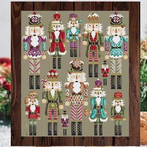 May include: A collection of 13 colourful nutcracker figurines with various designs and patterns. The nutcrackers are arranged in a grid pattern on a green background.