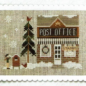 May include: A cross-stitch pattern depicting a winter scene with a post office building, a Christmas tree, and two figures standing in front of a mailbox. The post office has a sign that reads "POST OFFICE" and a window with a wreath. The building is decorated with white trim and a brown roof. The Christmas tree is green and has a red bird perched on top. The figures are wearing brown coats and hats. The scene is set against a background of white snow.