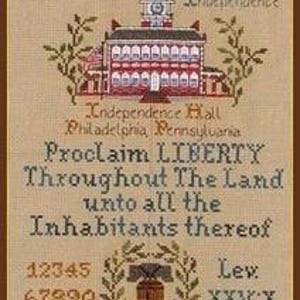 May include: A cross-stitch sampler featuring Independence Hall and the Liberty Bell. The text includes dates, phrases like "Proclaim Liberty," and the alphabet. The color palette is primarily tan, brown, red, and blue.