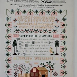 May include: A vintage cross-stitch pattern titled "Antique Museum Samplers" adapted from the Cooper-Hewitt Museum collection. The design includes an alphabet, numbers, and a sampler verse. The pattern features a house, trees, and floral elements.