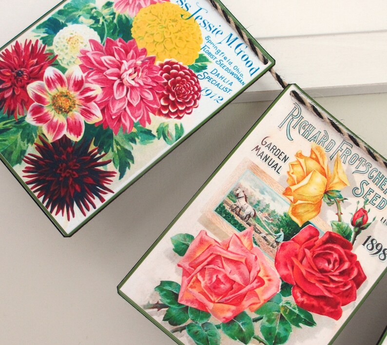 May include: Vintage seed packet banner with two panels. The first panel features a bouquet of colourful dahlias and the text "Jessie M. Good Springfield, Ohio Florist Seedswoman Dahlia Specialist 1972". The second panel features a bouquet of roses and the text "Richard Frotscher Seed Garden Manual 1898".