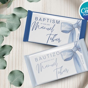 May include: Two chocolate bar wrappers with blue accents and text. One reads "Baptism of our son Manuel Tobar" and the other "Bautizo de nuestro hijo Manuel Tobar". Both have a blue bow illustration and dates.