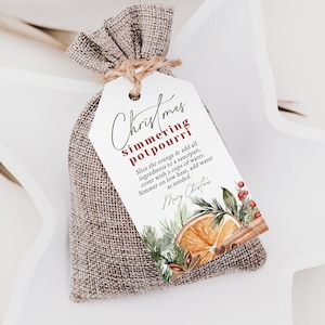 May include: A small hessian bag with a white tag that says "Christmas Simmering Potpourri" and instructions for use. The tag has a watercolour illustration of an orange slice, cinnamon sticks, and greenery.