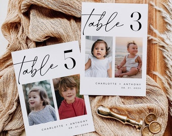 May include: Two white table number cards with black calligraphy that reads "table" and a large black number. The cards feature photos of a young girl and boy. The text below the photos reads "Charlotte + Anthony 08.21.202X".