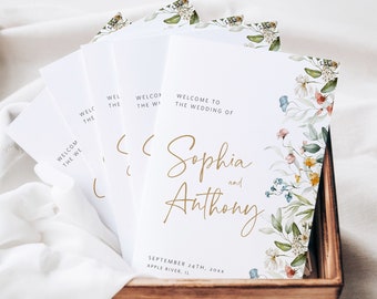 May include: Wedding ceremony program with a floral design featuring white, pink, and blue flowers. The program is titled "Welcome to the Wedding of Sophia and Anthony" with the date and location printed below.