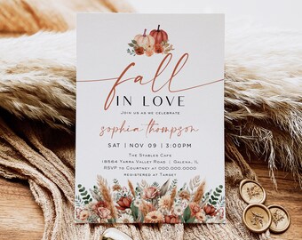 May include: Fall in love wedding invitation with a watercolor illustration of pumpkins and fall foliage. The invitation is for Sophia Thompson and is set for November 9th at 3:00 PM at The Stables Cafe in Galena, Illinois. RSVP to Courtney at 000.000.0000. Registered at Target.