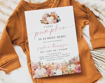 May include: A white card with a fall-themed baby shower invitation. The card features a watercolor illustration of pumpkins, flowers, and leaves. The text on the card reads "A Little Pumpkin is Almost Here!" and includes the baby's name, date, time, and location.
